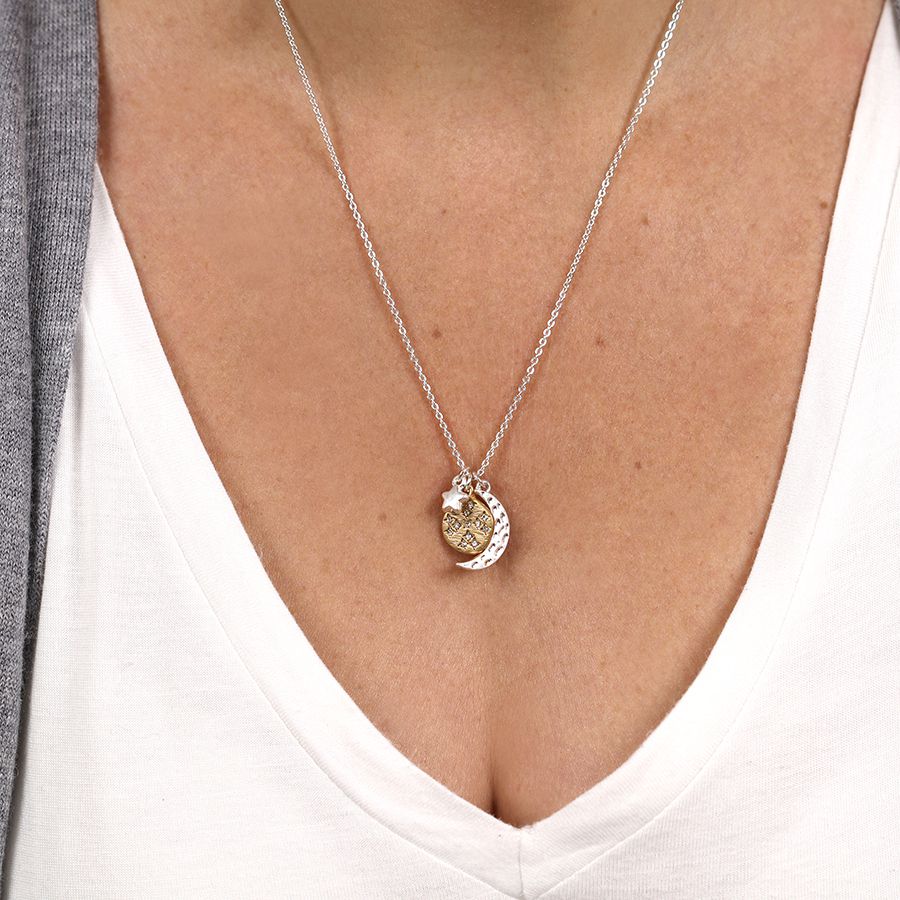 Necklace with a pendant worn by a person, close-up on a plain background