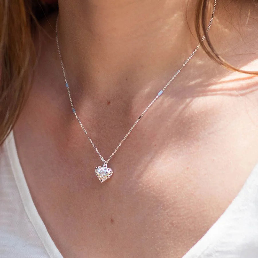 Necklace with a heart-shaped pendant worn by a person