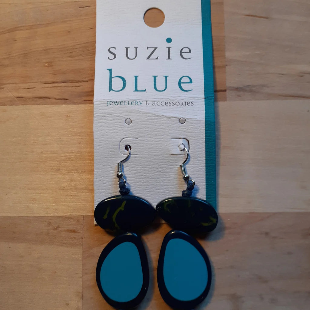 Blue and black earrings on a 'suzie blue' branded card on a wooden surface