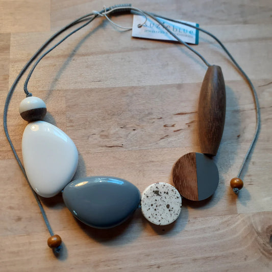 Necklace with wooden and ceramic beads on a wooden surface