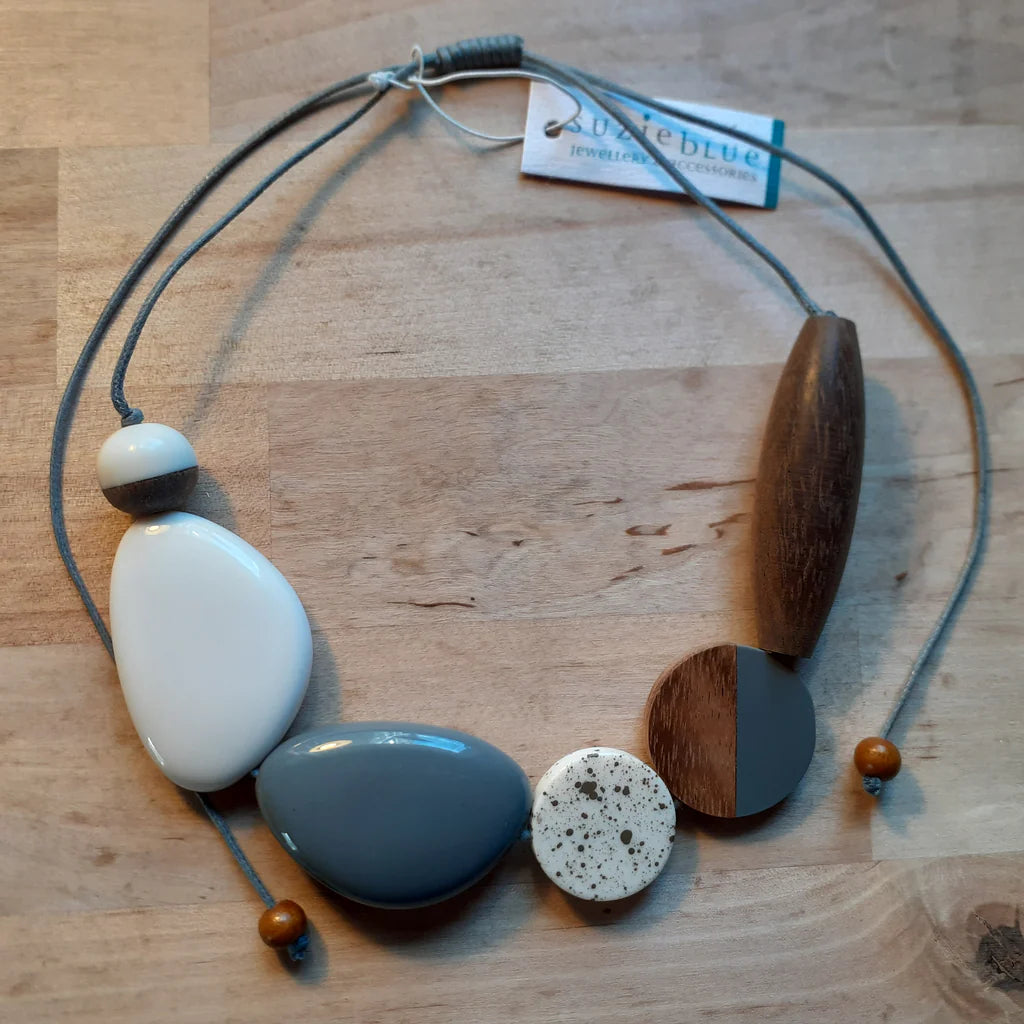 Necklace with wooden and ceramic beads on a wooden surface