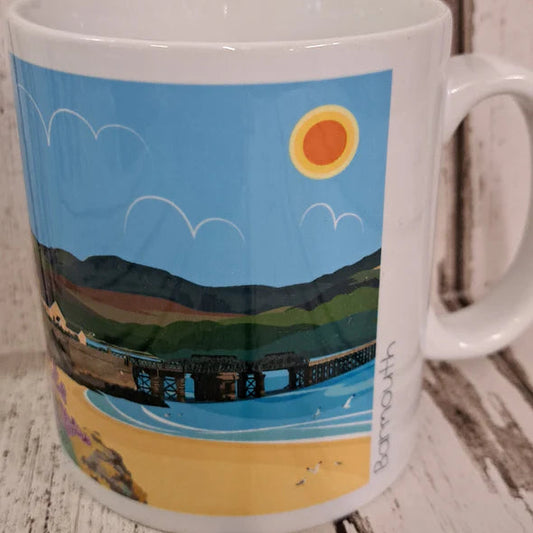Mug with scenic design of a dock and mountains on a wooden surface