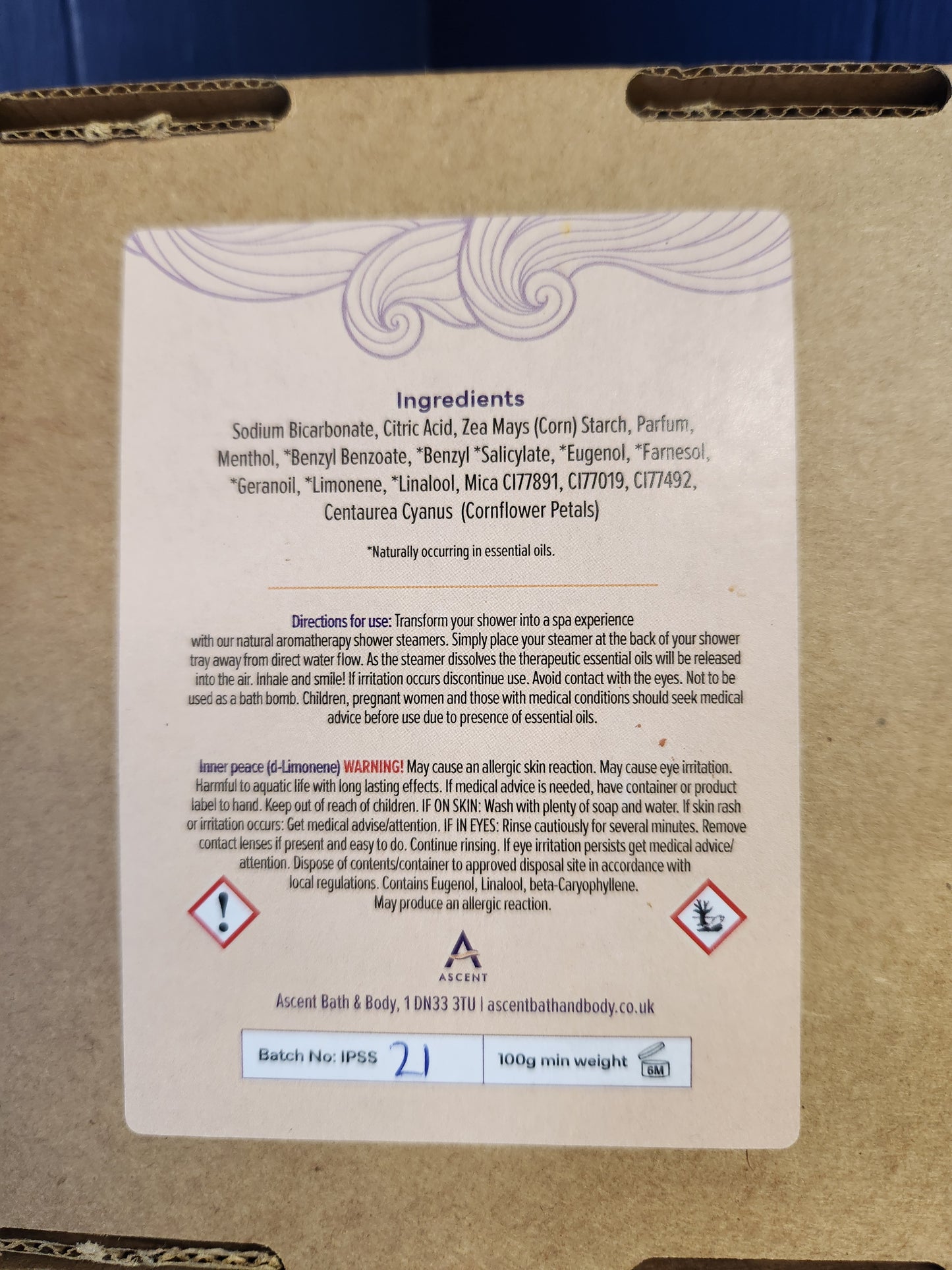 Cardboard box with a label containing text and symbols on a blue background