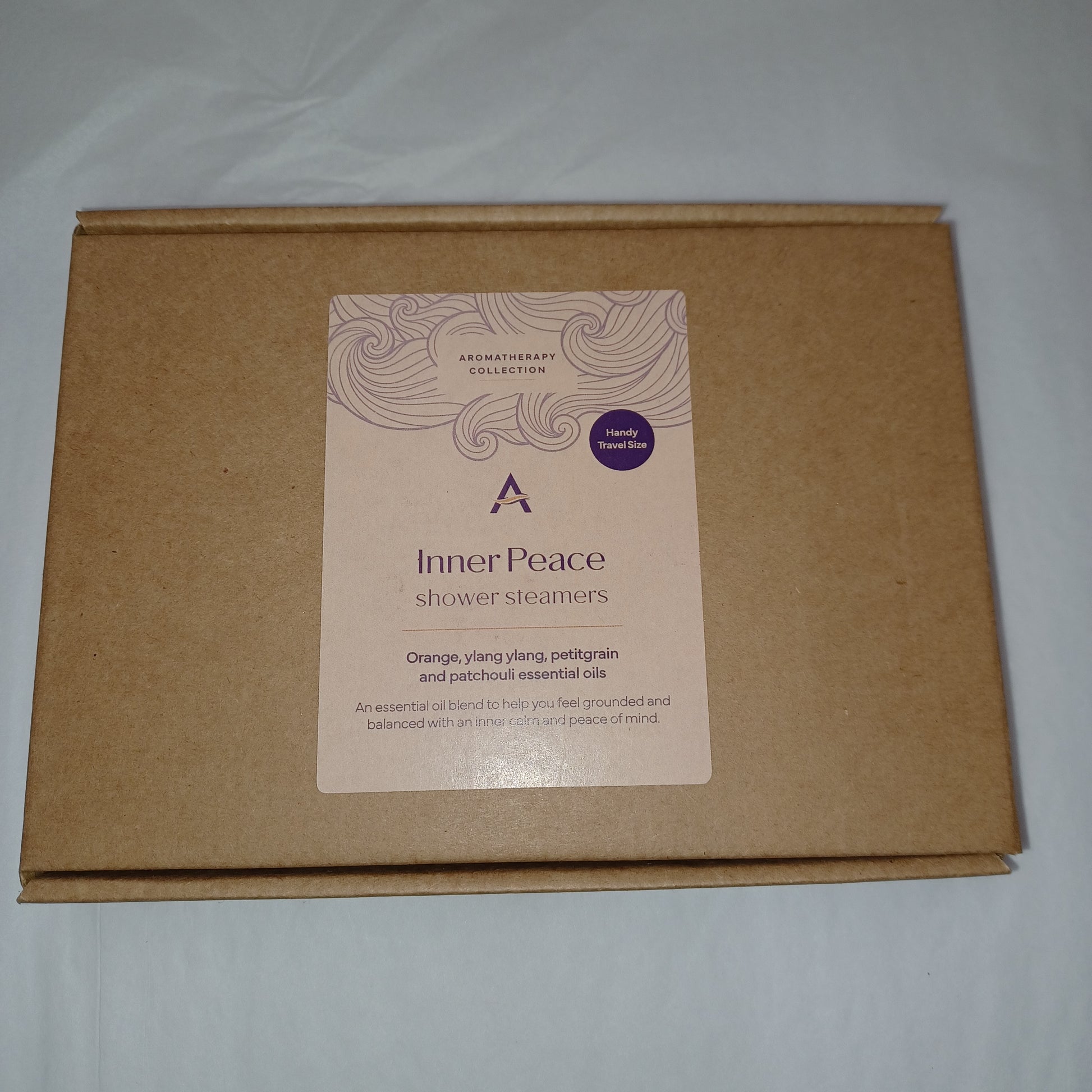 Brown cardboard box with a 'Inner Peace' product label on a white background