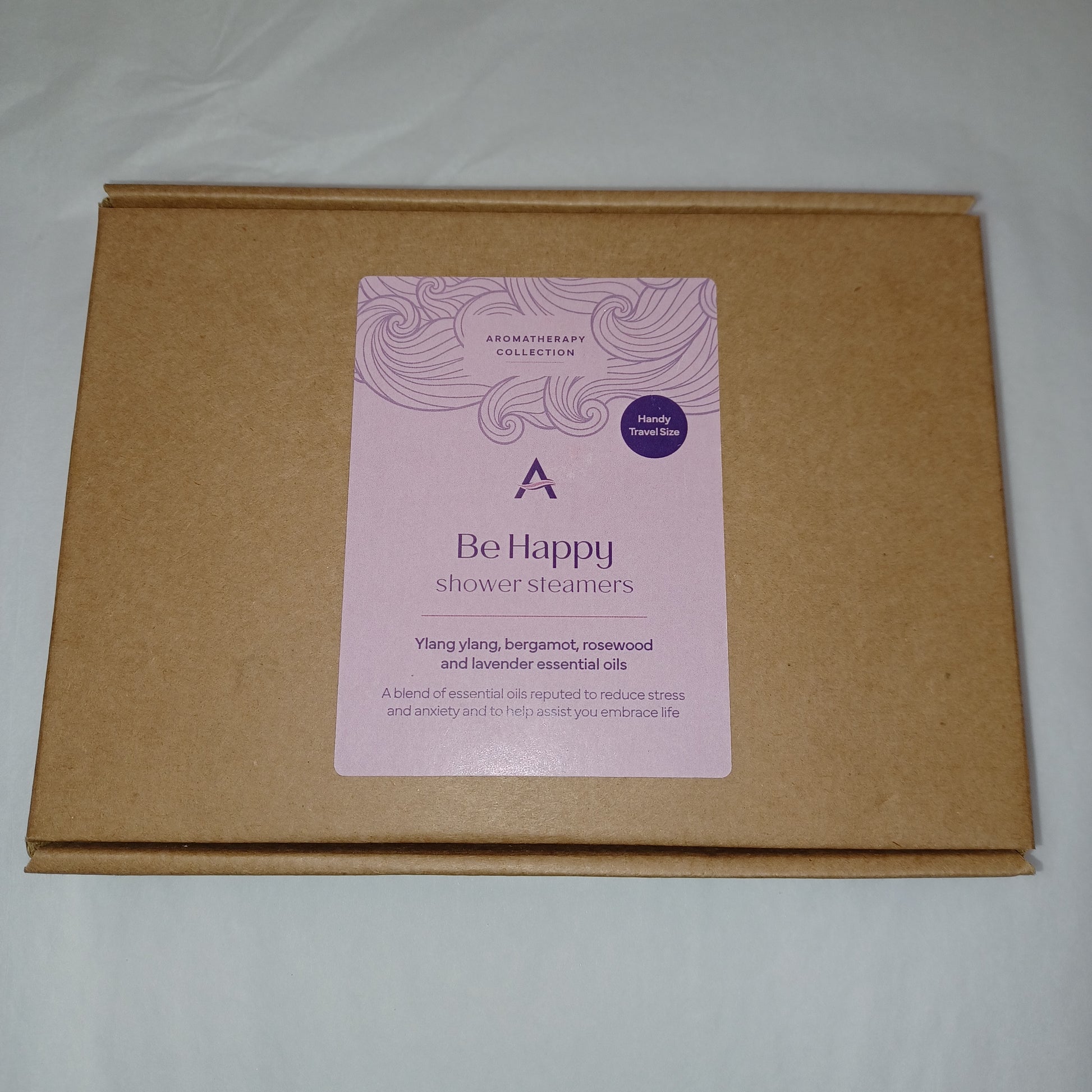 Brown cardboard box with a pink label on a light gray background