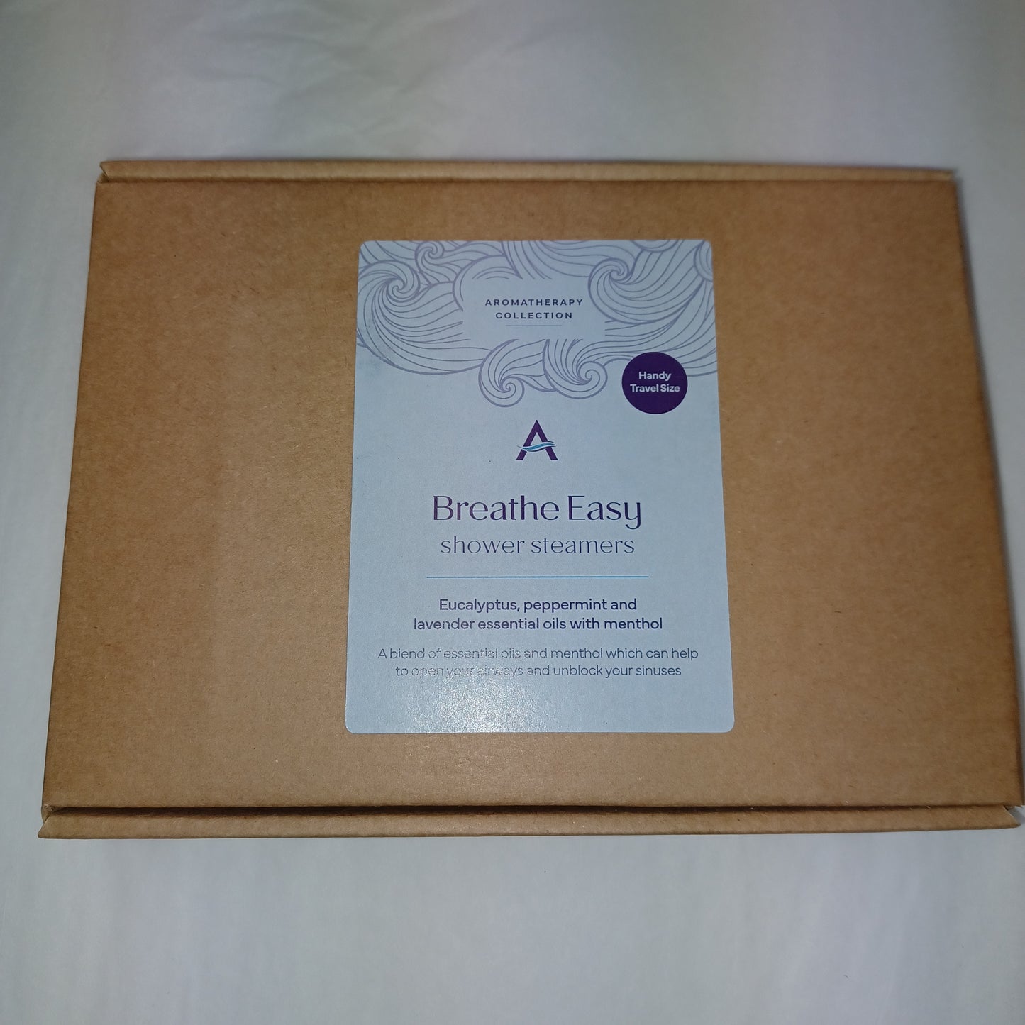 Brown cardboard box with a 'Breathe Easy' product label on a white background