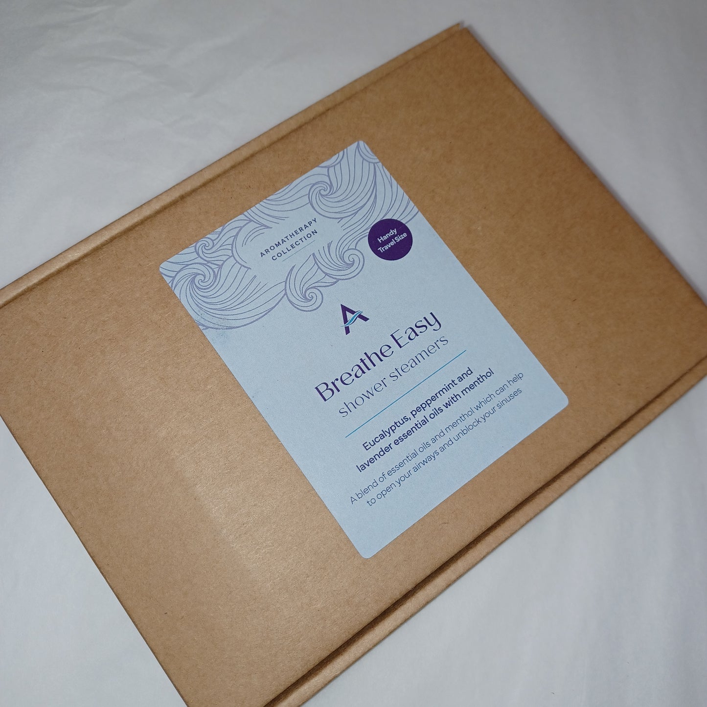 Brown box with a purple and white label on a light gray background