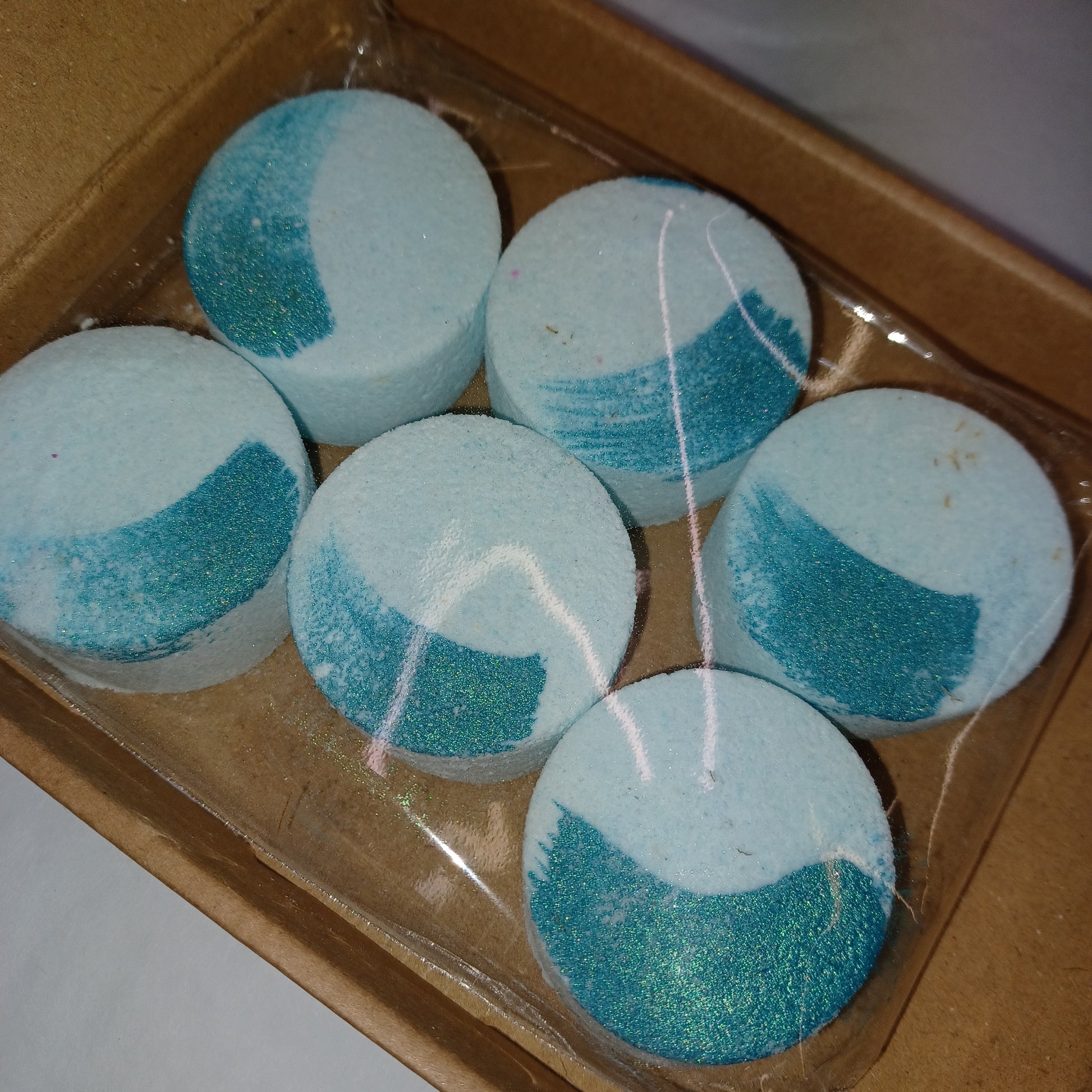 Blue and white bath bombs in a cardboard box