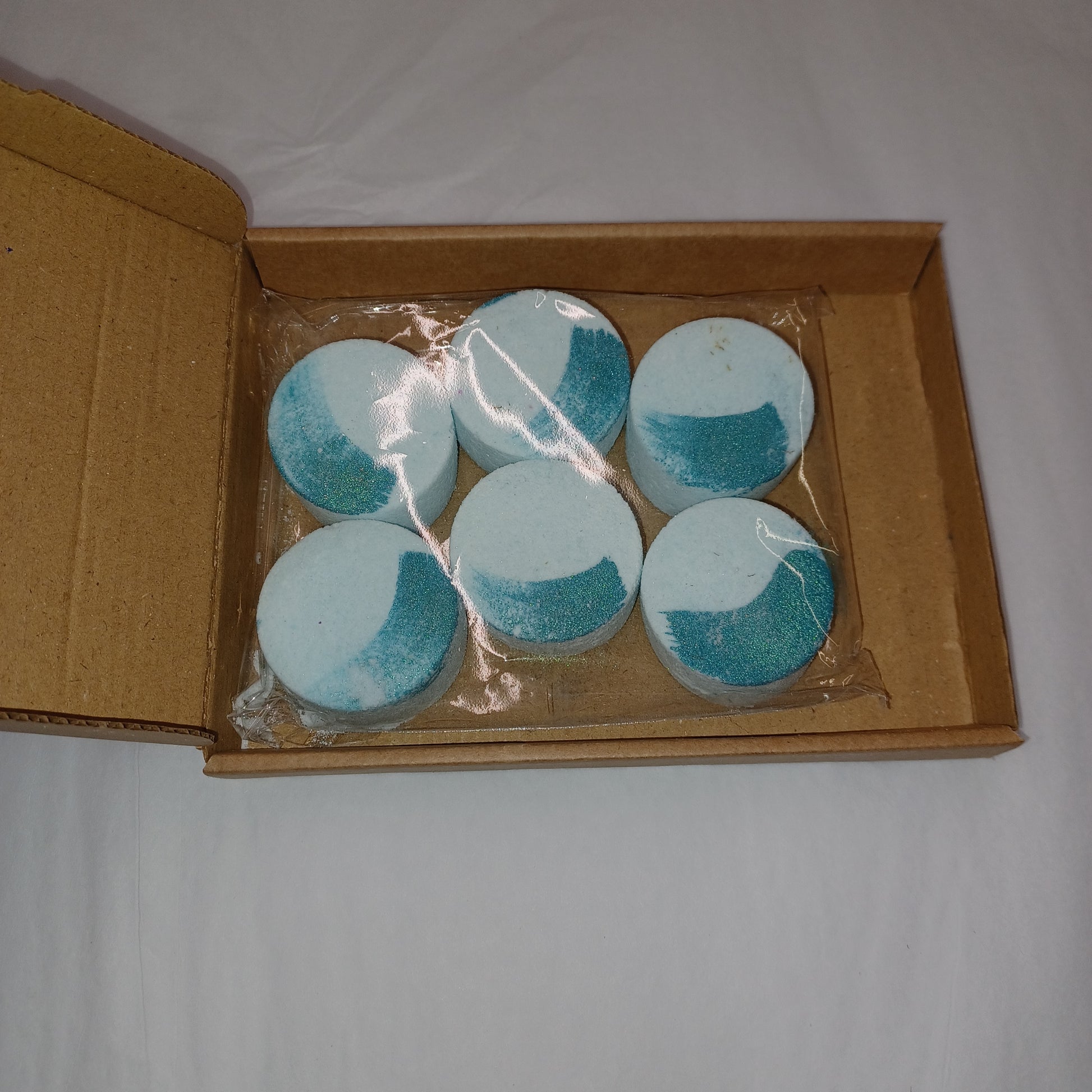 Box of blue and white circular items on a plain background