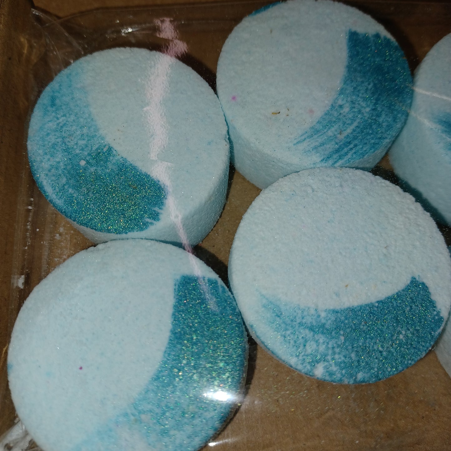 Blue and white shower steamers on a brown surface
