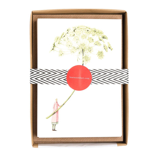 Framed artwork with a dandelion illustration and a person holding a stick, branded 'laurastoddard'.