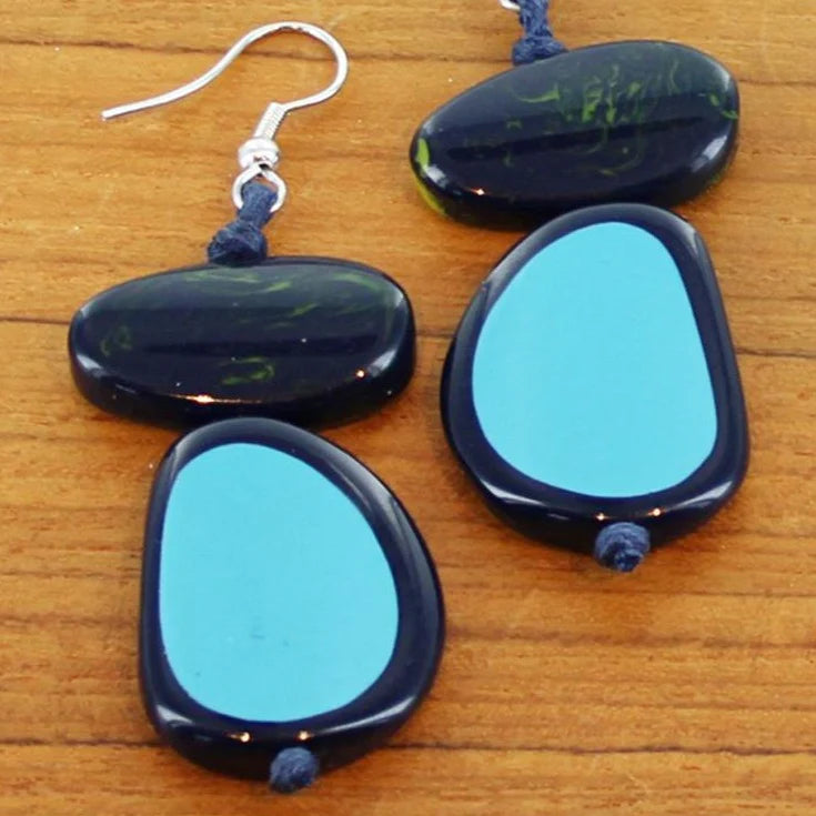 Blue and black stone earrings on a wooden surface