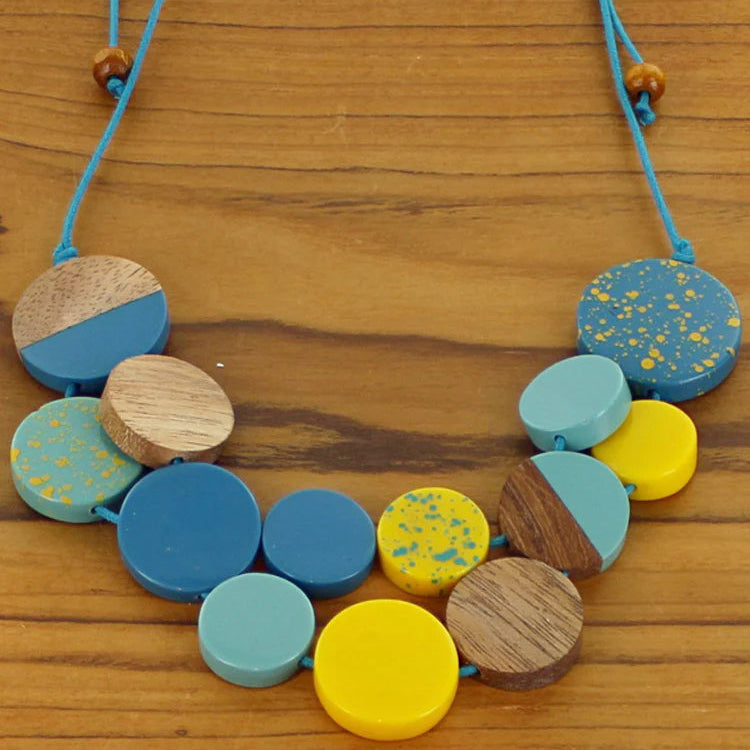 Necklace with colorful beads on a wooden surface