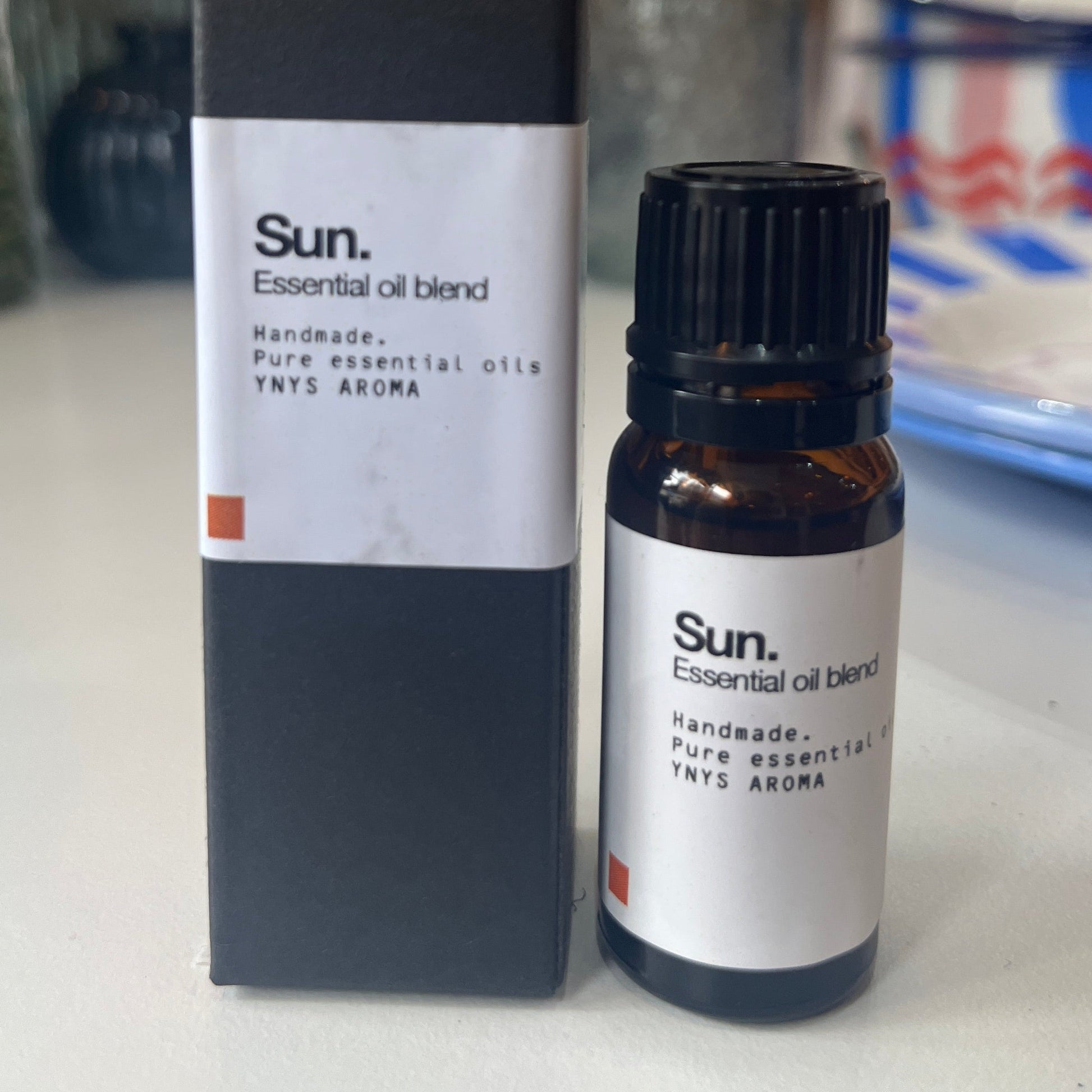 Essential oil bottle and box on a blurred background