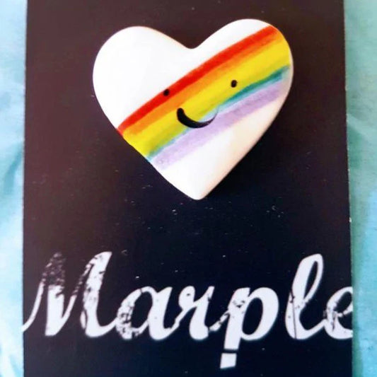 Heart-shaped rainbow pin with a smiley face on a black background with 'Marple' branding.