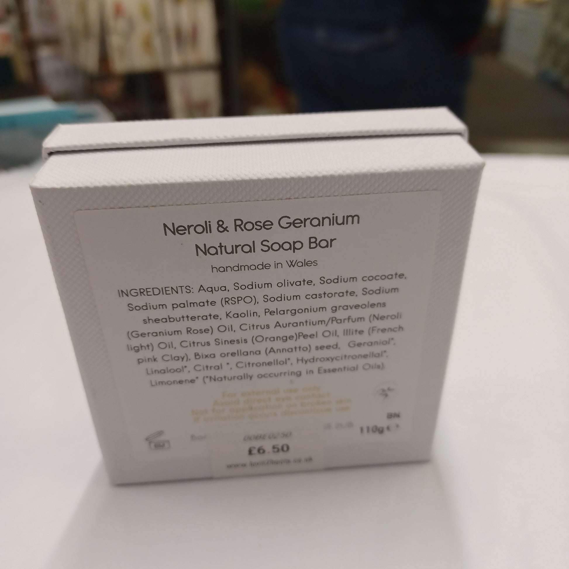 Neroli & Rose Geranium natural soap bar packaging with ingredient list on a white background