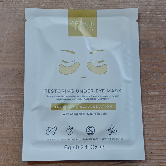 Under eye mask packaging with brand name on a wooden surface
