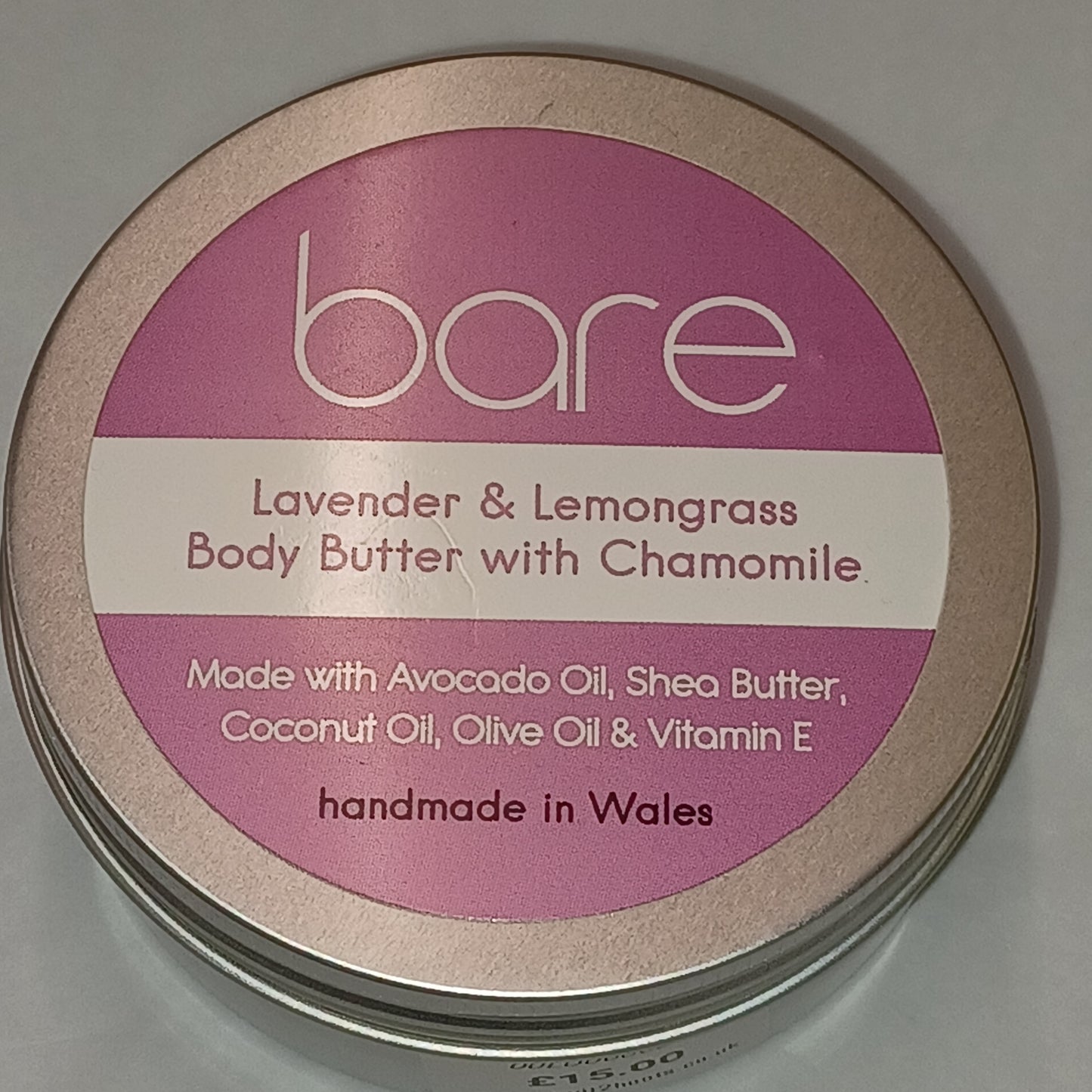 Bare Lavender & Lemongrass Body Butter container with pink label on a gray background
