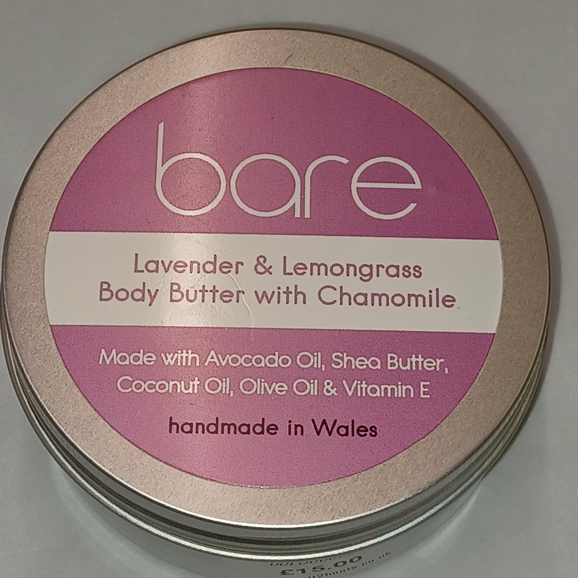 Bare Lavender & Lemongrass Body Butter container with pink label on a gray background
