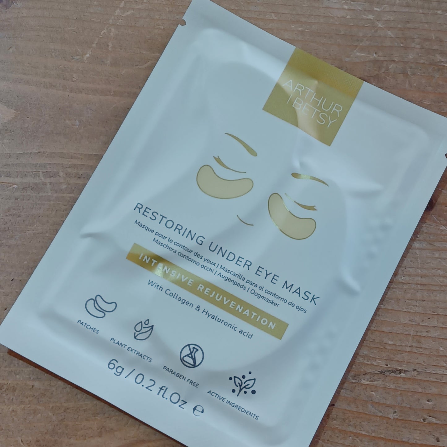 Under eye mask packaging on a wooden surface