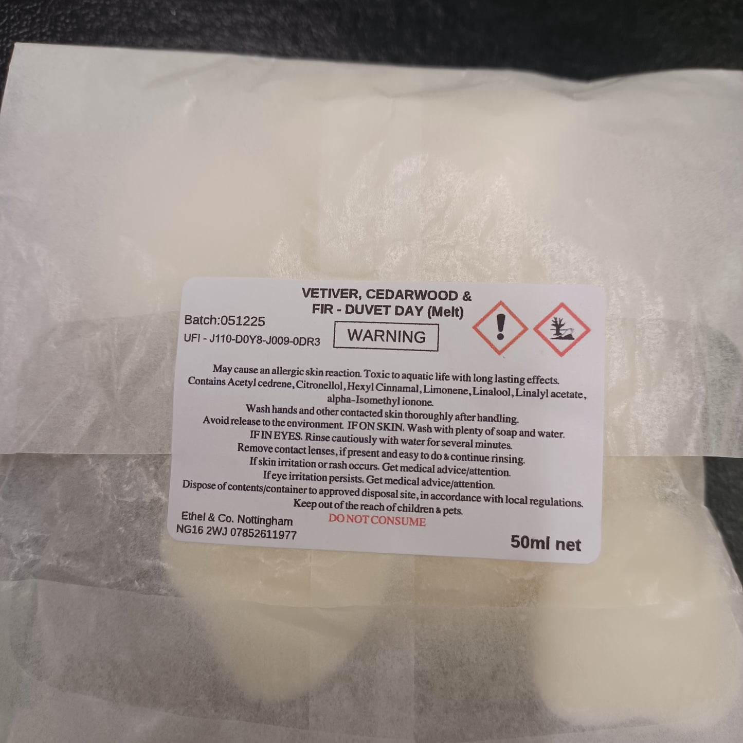 Product packaging with a warning label on a white background