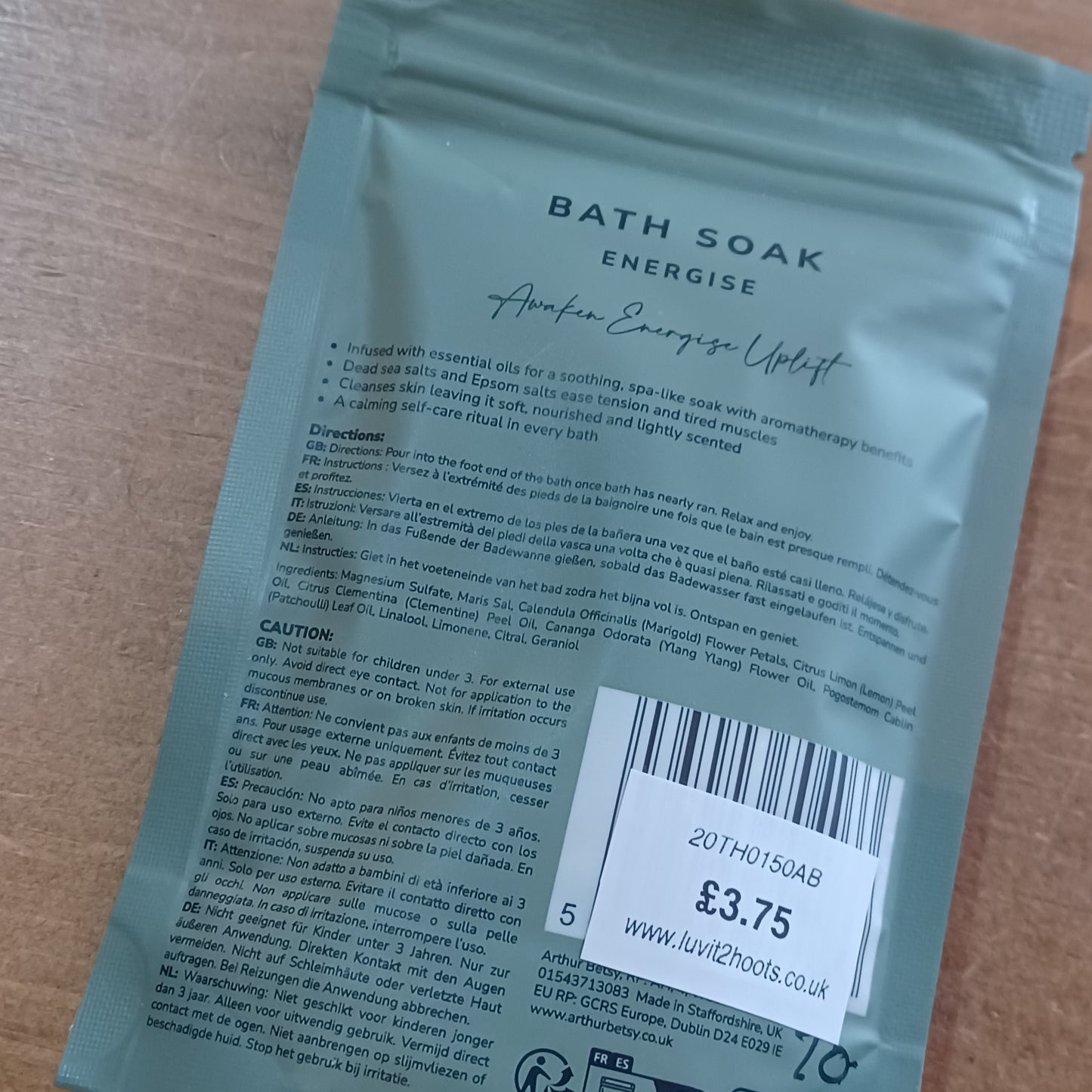 Bath soak packaging with text and barcode on a wooden surface