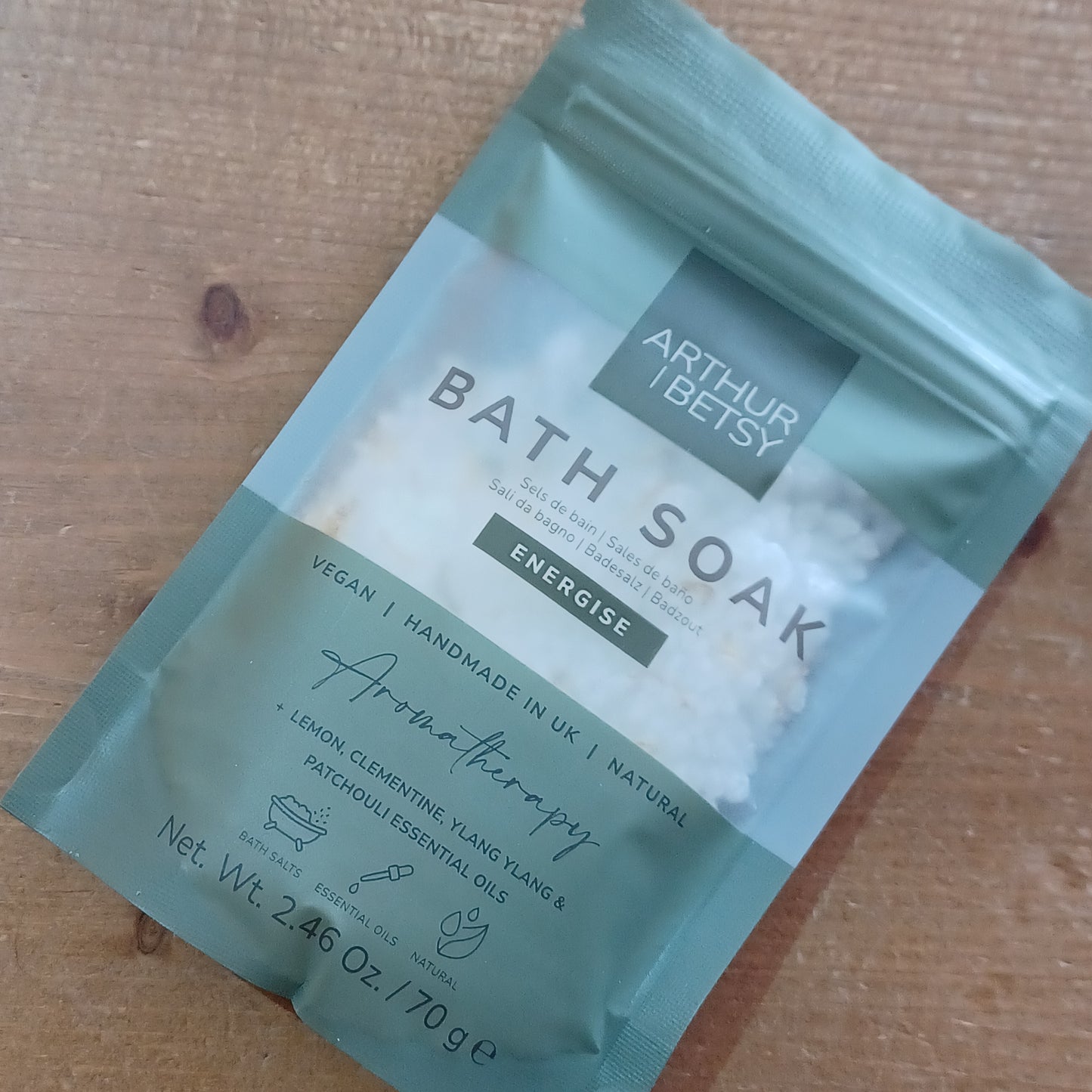 Bath soak package with branding on a wooden surface