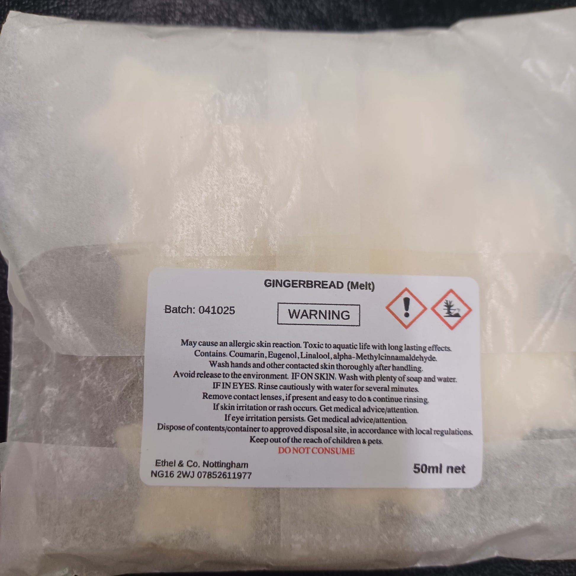 Packaged gingerbread with a warning label on a white background
