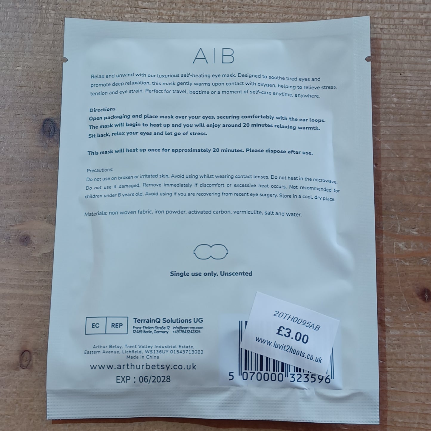 White sachet with text and a barcode on a wooden surface