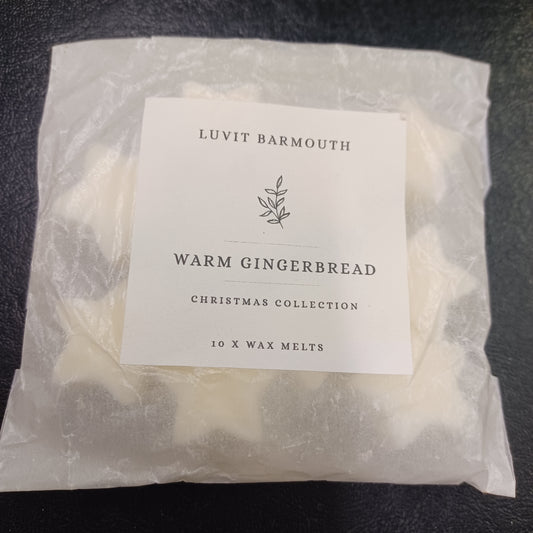Packaged wax melts with a label on a dark surface