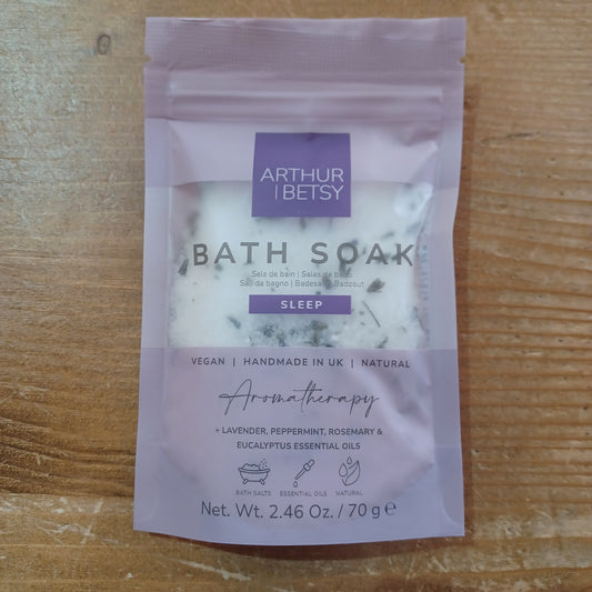 Bath salt packet labeled 'Arthur & Betsy' on a wooden surface