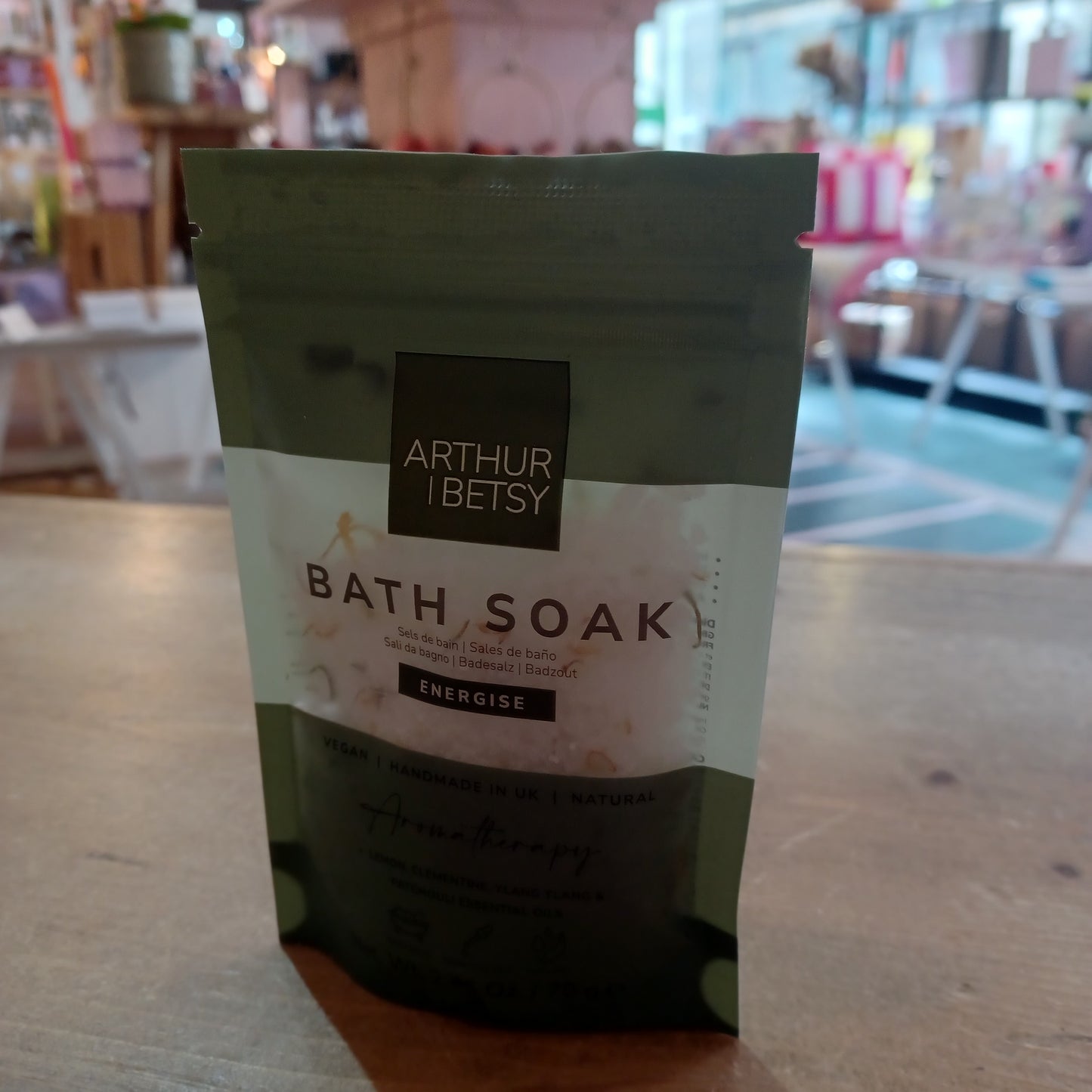 Bath soak packaging with 'Arthur & Betsy' branding on a wooden surface.