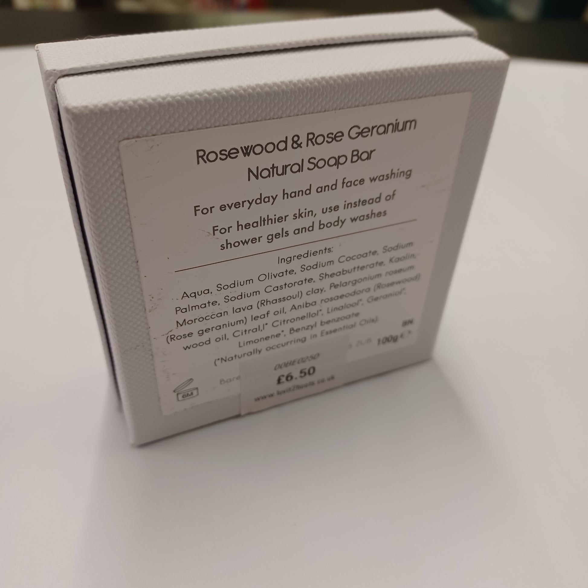 Box with Rosewood & Rose Geranium soap bar label on a white background