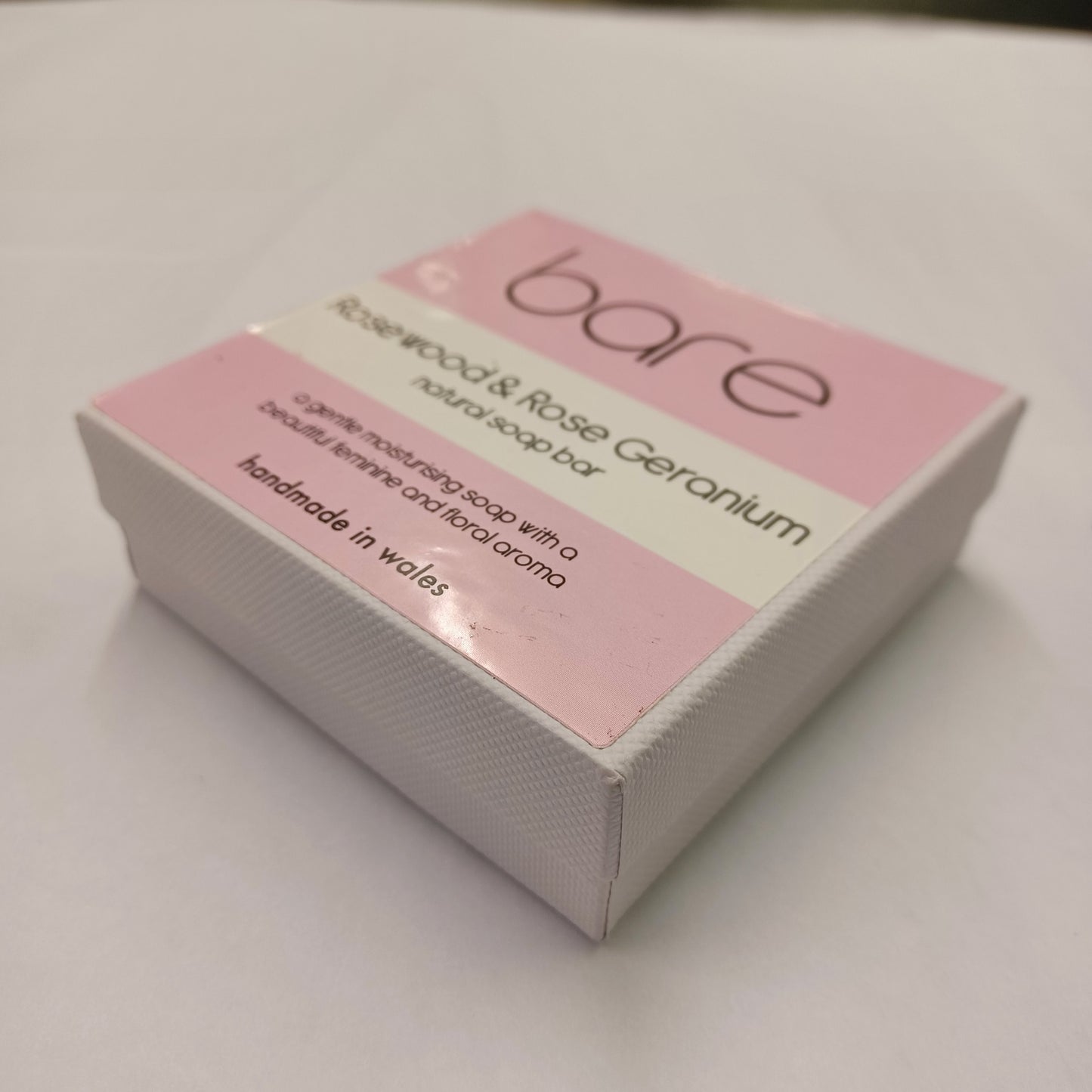Box of 'bare' soap bar with pink label on a white background